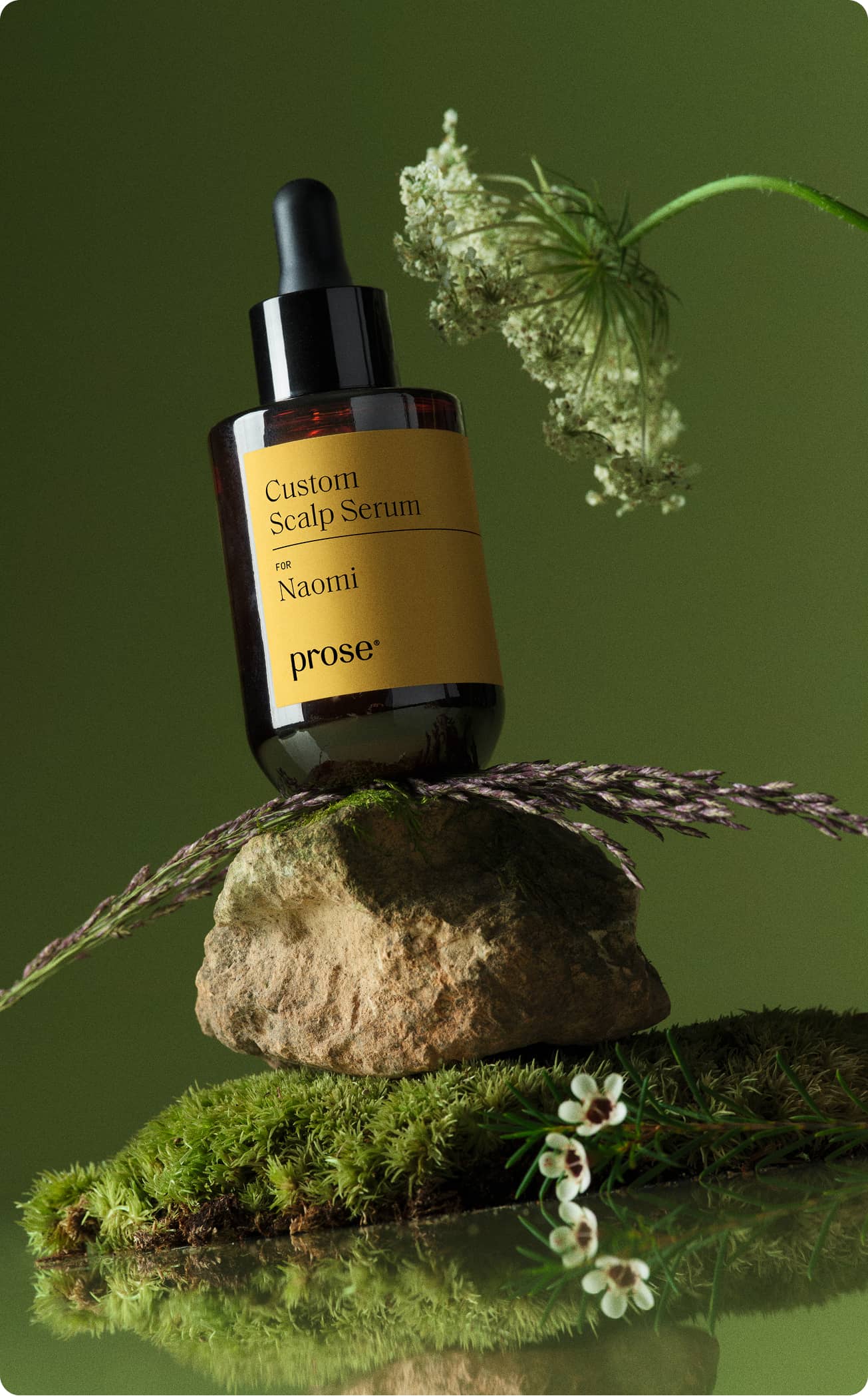 Close-up-of-a-Prose-Custom-Scalp-Serum-bottle-with-ingredients-and-greenery.jpg